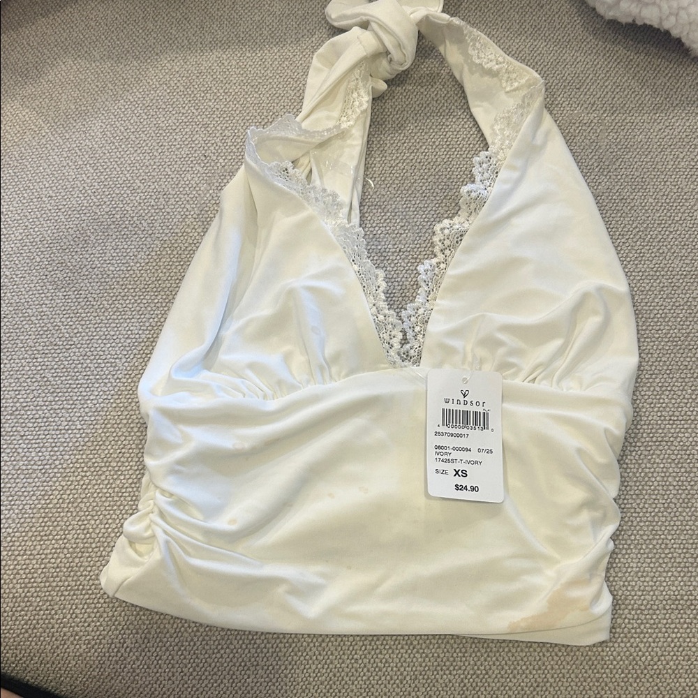 Please see stains on shirt. Brand new with tags but stains